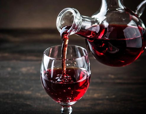 Pouring red wine from carafe